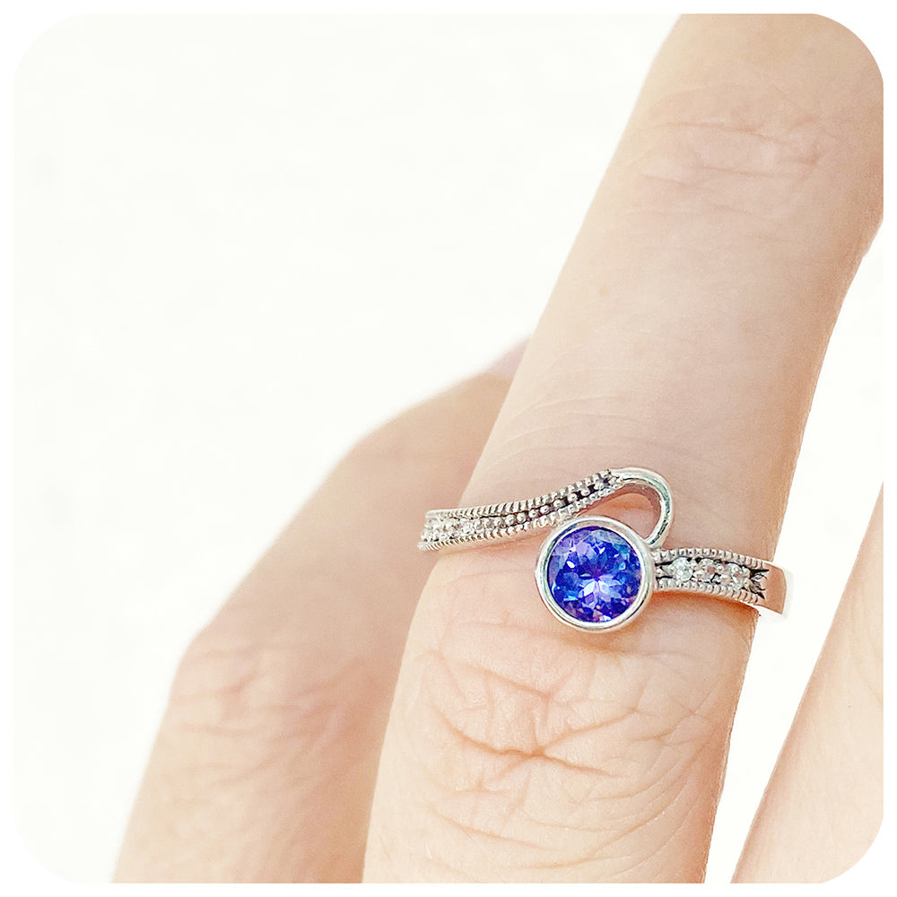 Round cut tanzanite and cubic zirconia dress ring