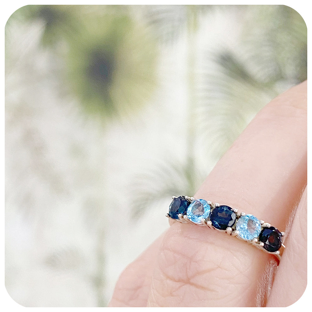 brilliant cut blue topaz half eternity anniversary or birthstone ring