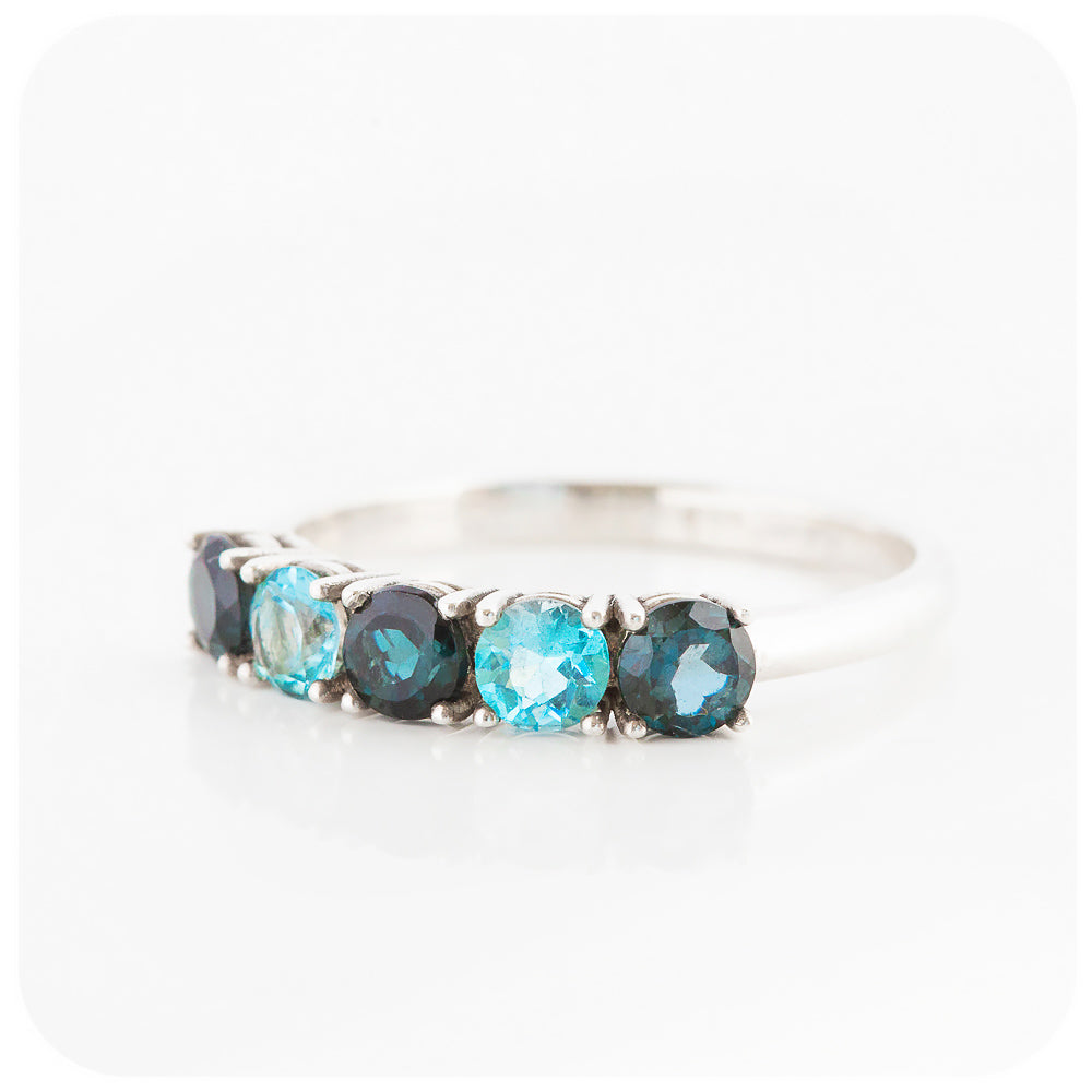 brilliant cut blue topaz half eternity anniversary or birthstone ring