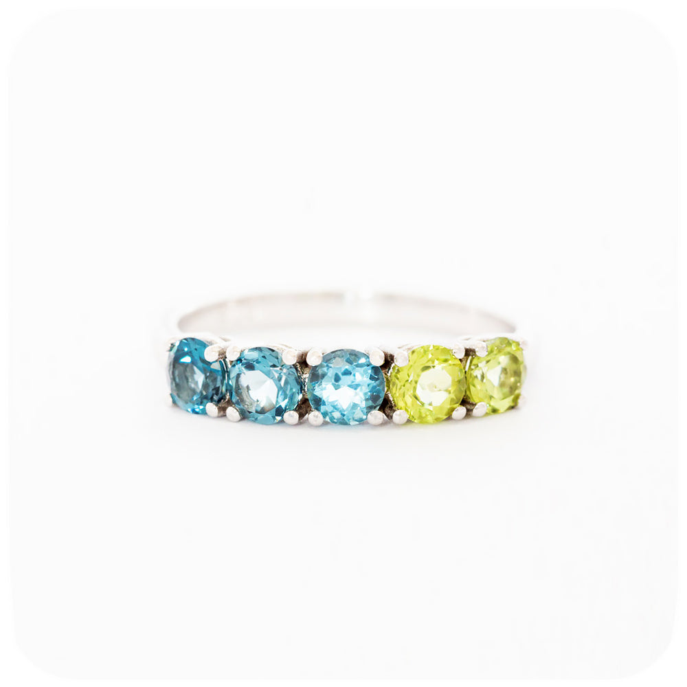 brilliant cut topaz and peridot half eternity anniversary ring