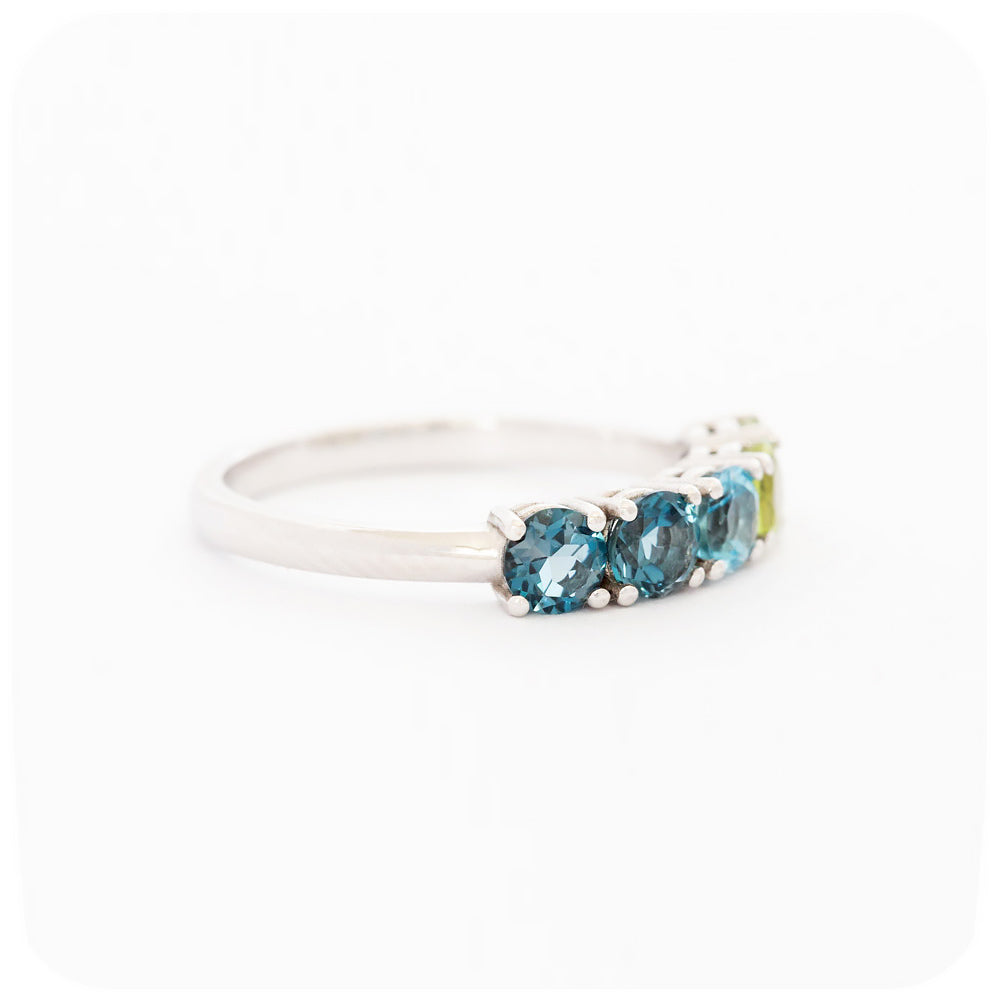 brilliant cut topaz and peridot half eternity anniversary ring