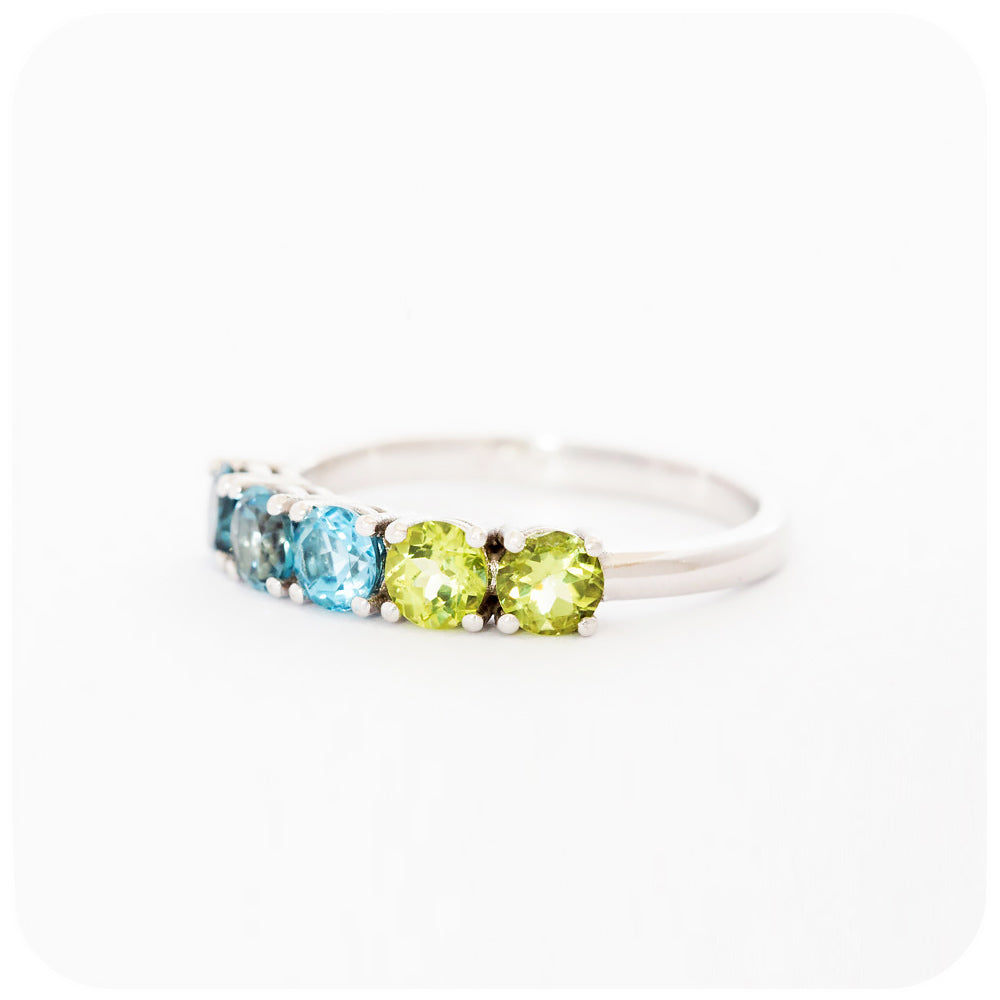 brilliant cut topaz and peridot half eternity anniversary ring