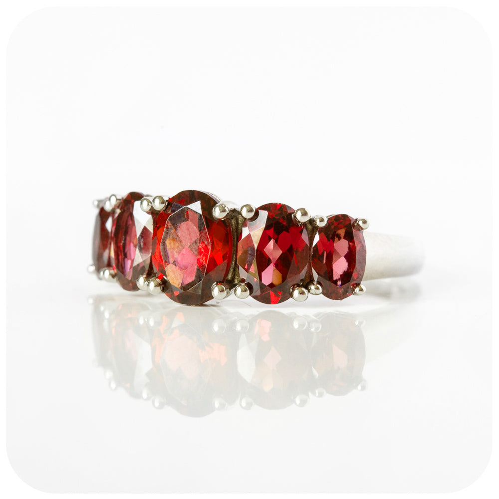 oval cut red garnet half eternity anniversary or birthstone ring