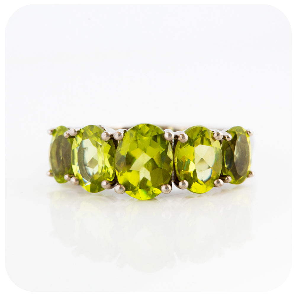 oval cut green peridot half eternity anniversary ring