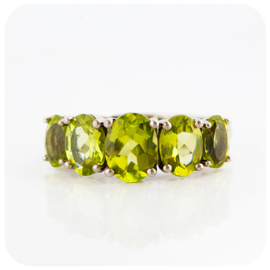 oval cut green peridot half eternity anniversary ring