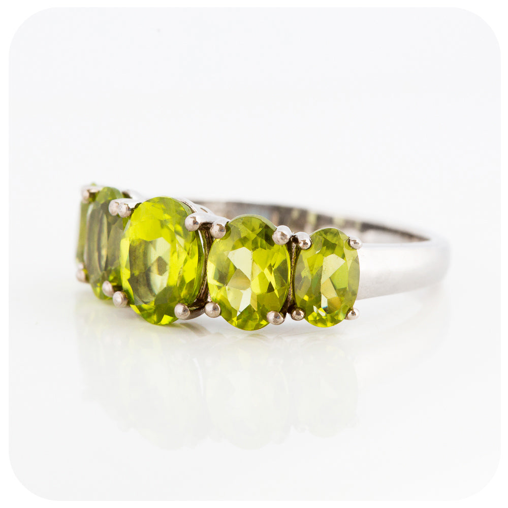 oval cut green peridot half eternity anniversary ring