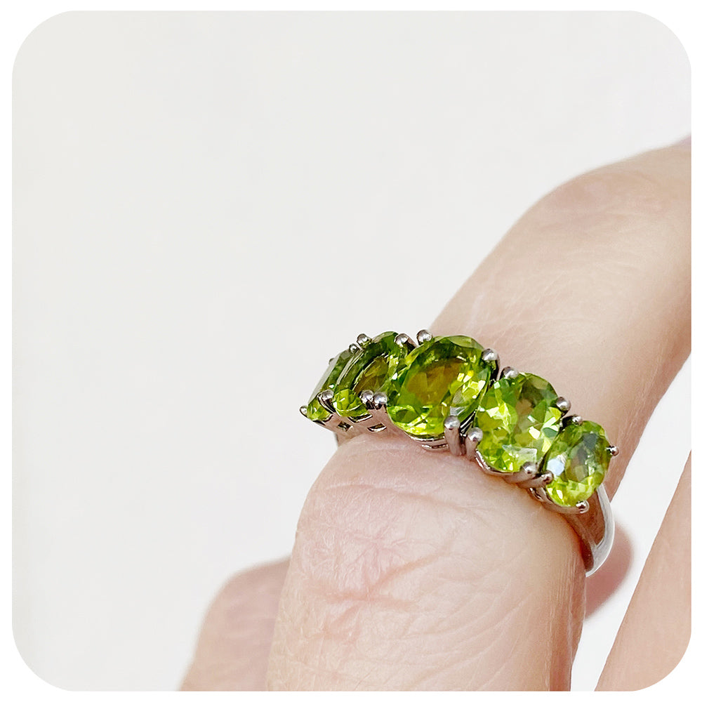 oval cut green peridot half eternity anniversary ring