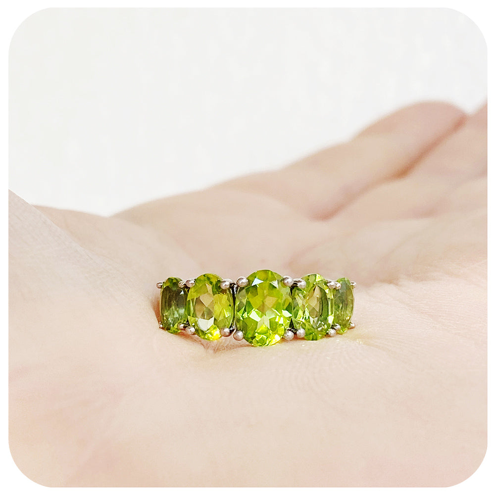oval cut green peridot half eternity anniversary ring