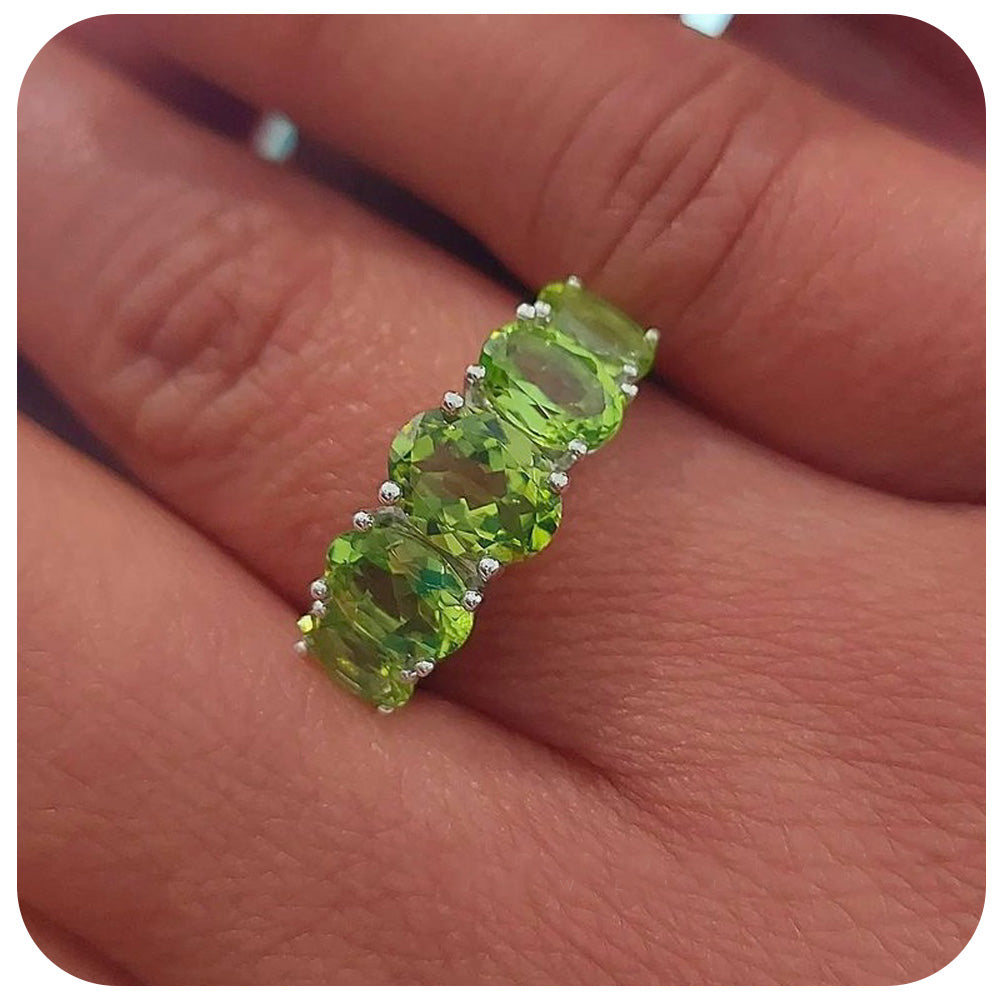 oval cut green peridot half eternity anniversary ring