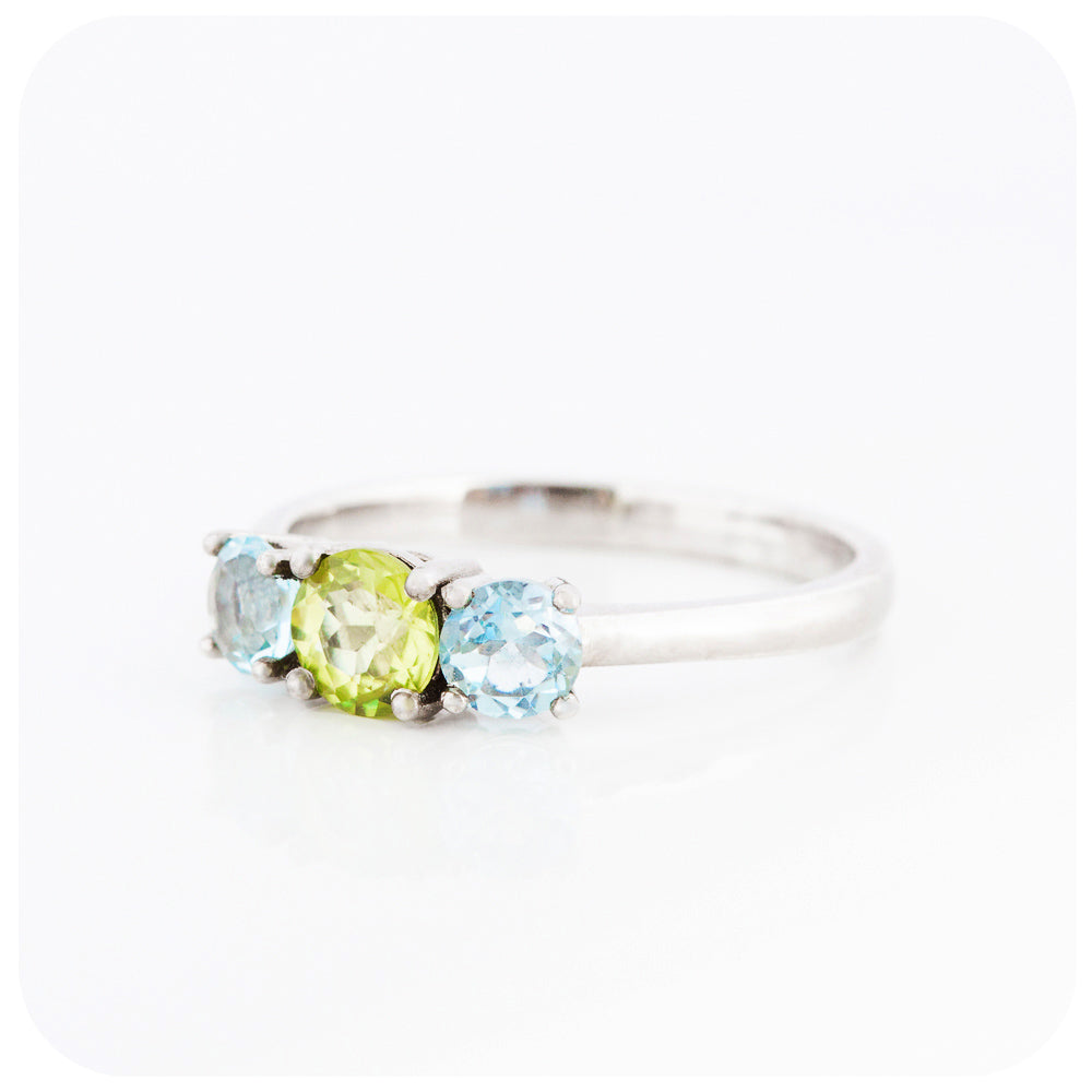 Peridot and Sky Blue Topaz Round cut Trilogy Ring