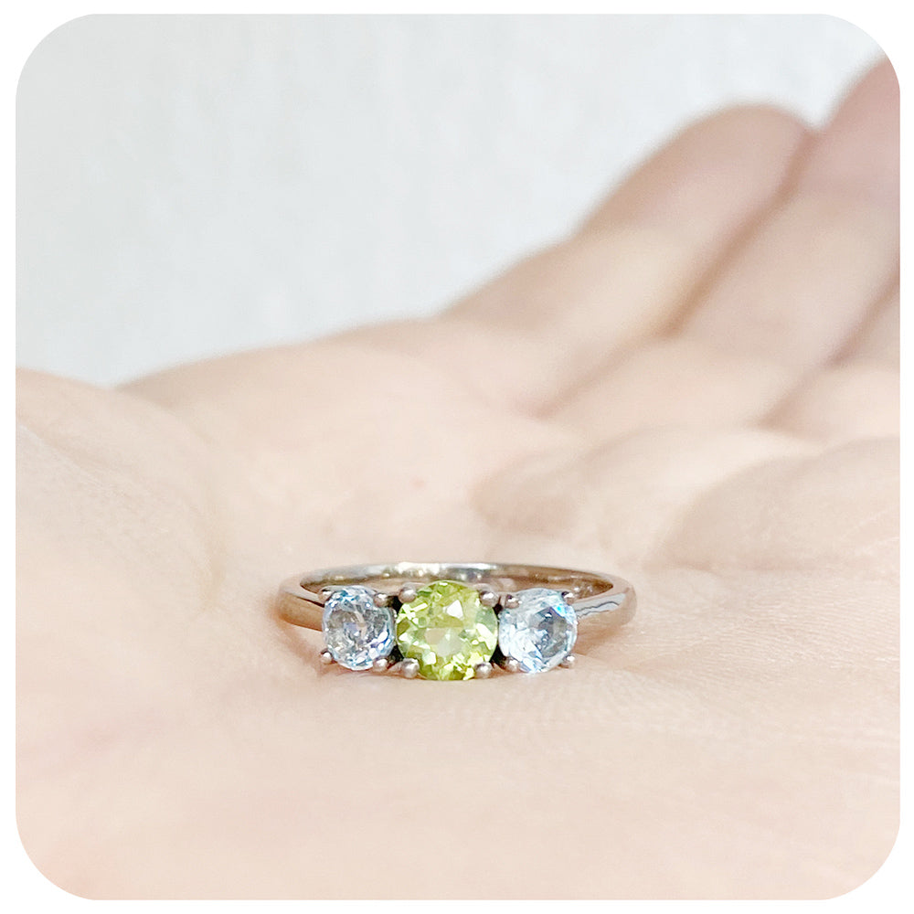 Peridot and Sky Blue Topaz Round cut Trilogy Ring