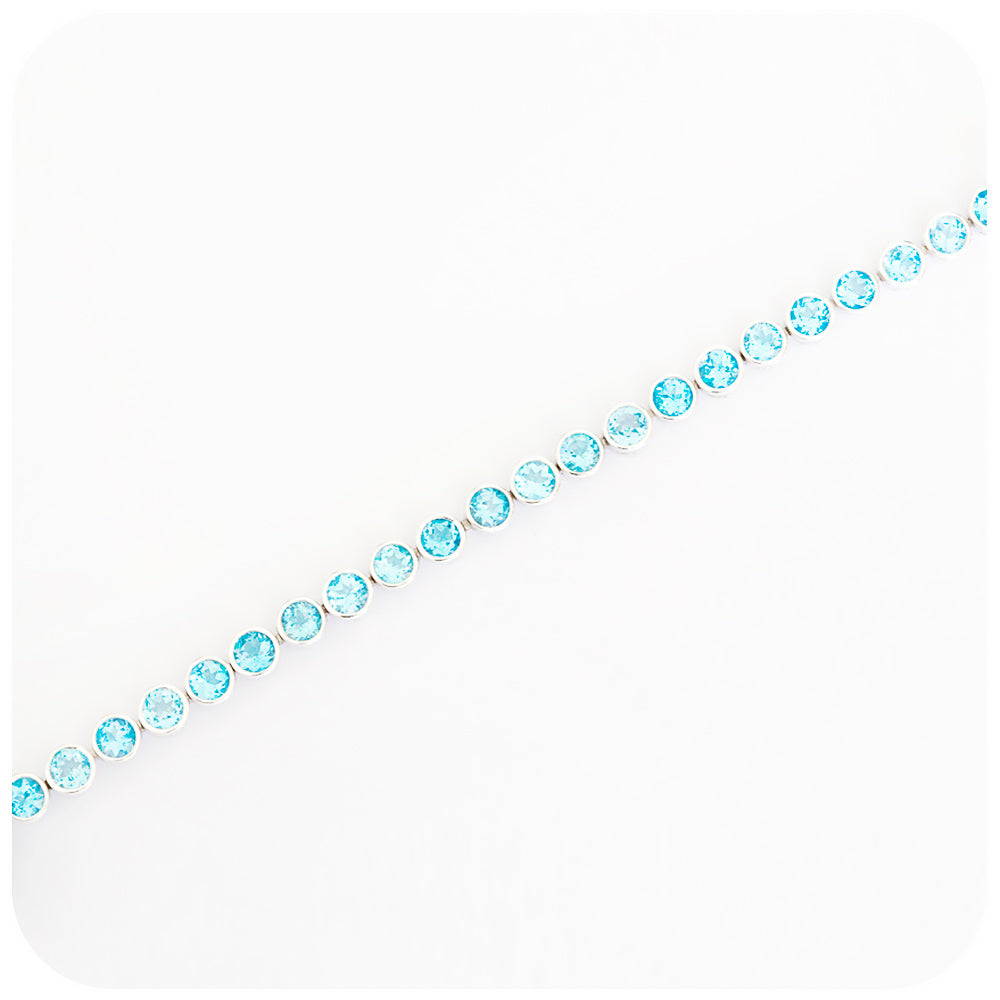 Round cut Swiss Blue Topaz Tennis Bracelet in Sterling Silver