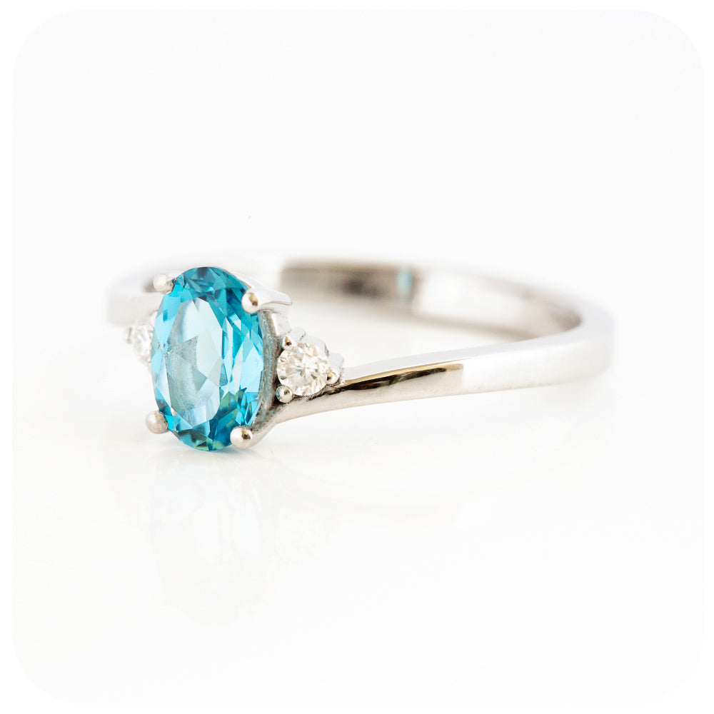 Oval cut Swiss Blue Topaz and Moissanite Trilogy Ring with a Twist