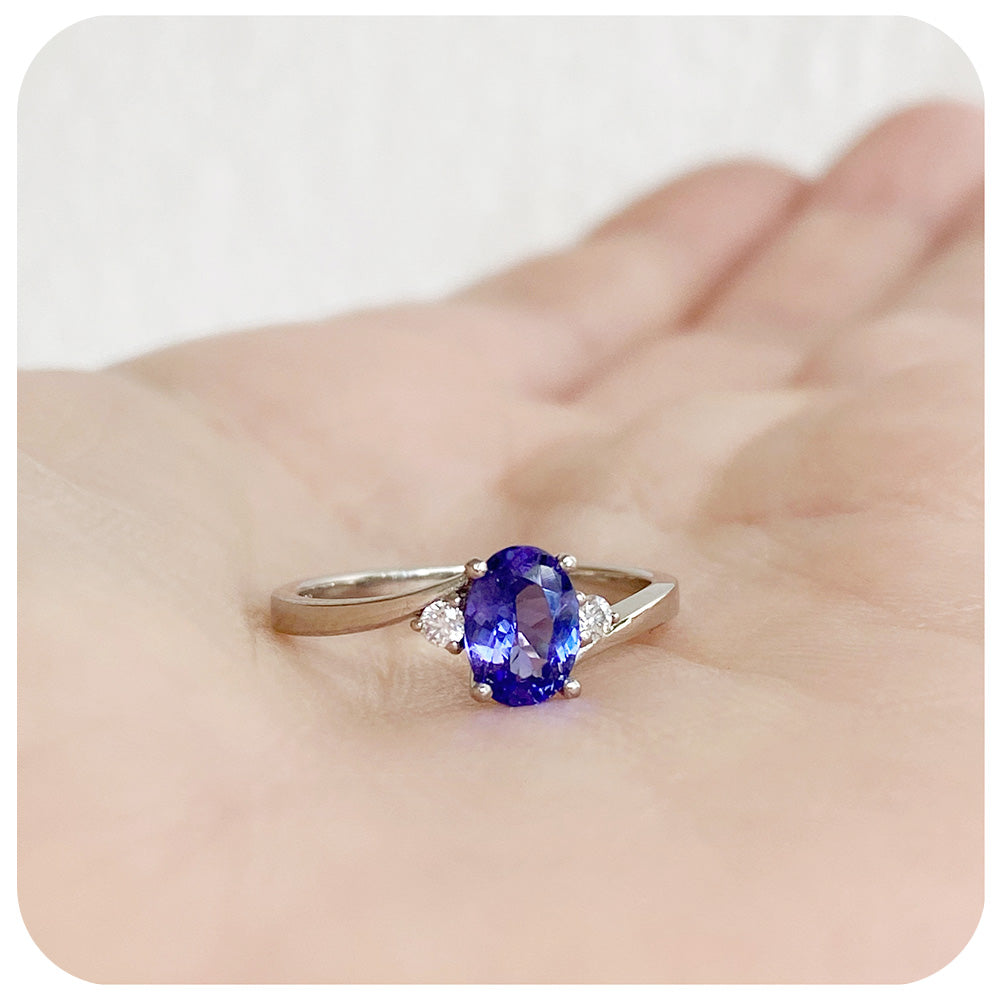 Oval cut Tanzanite and Moissanite Trilogy Ring with a Twist