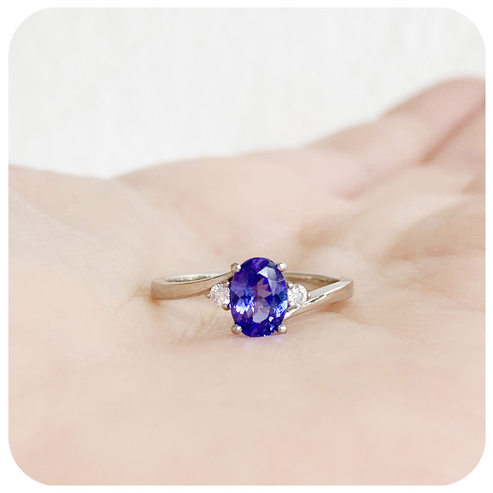 Oval cut Tanzanite and Moissanite Trilogy Ring with a Twist
