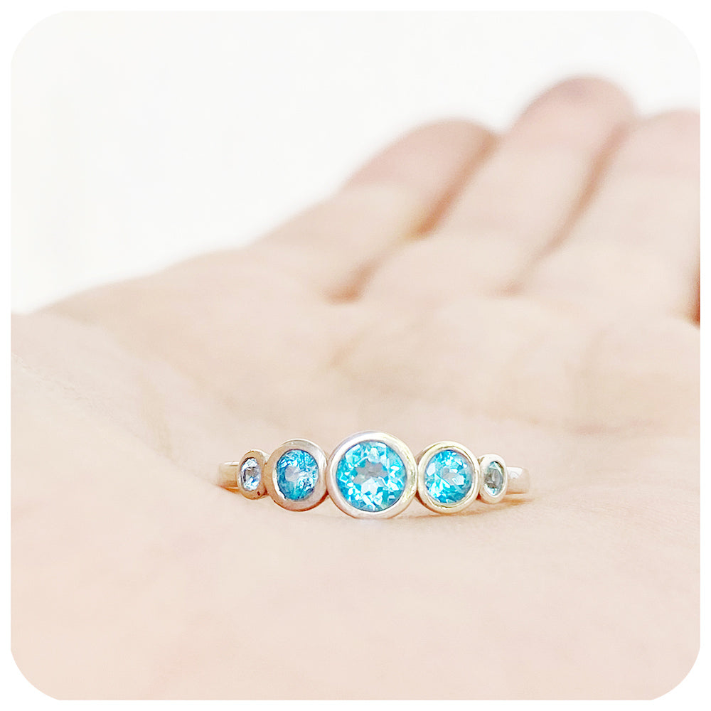 Gabriella, a Swiss Blue Topaz Half Eternity Ring