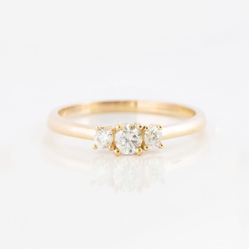 brilliant round cut moissanite trilogy engagement ring in yellow gold - Victoria's Jewellery