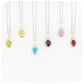 a collection of oval cut birthstone pendants with peridot, citrine, topaz, amethyst and garnet