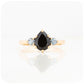 black pear cut spinel and round cut aquamarine trilogy style engagement ring in yellow gold - Victoria's Jewellery