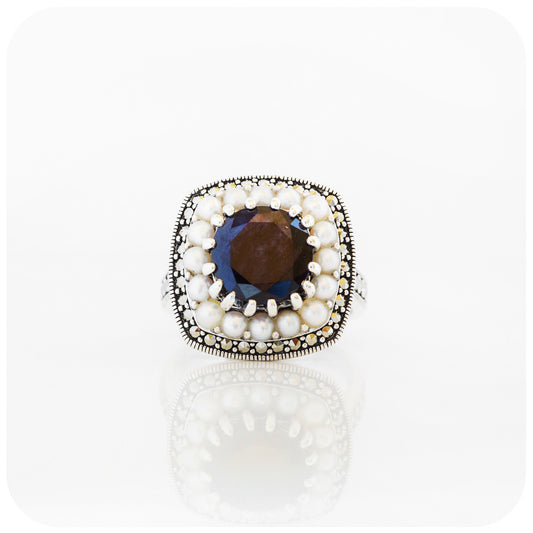 The cushion cut Sapphire and Fresh Water Pearl Ring
