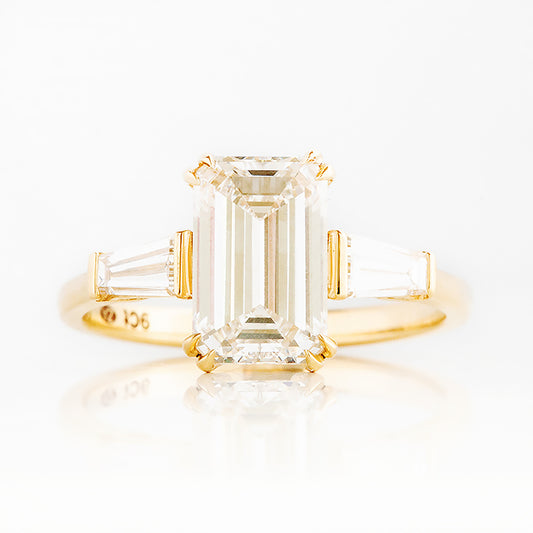 Carmen, an Emerald cut Trilogy Ring