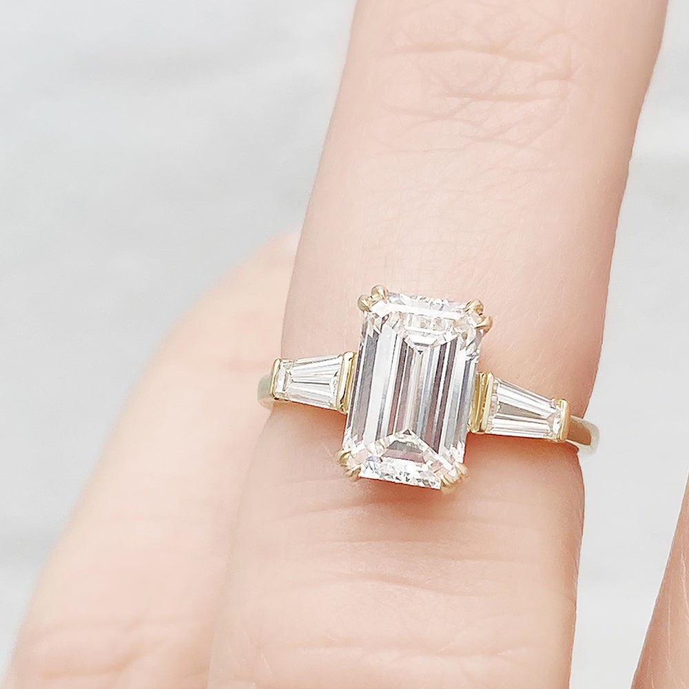 Carmen, an Emerald cut Trilogy Ring