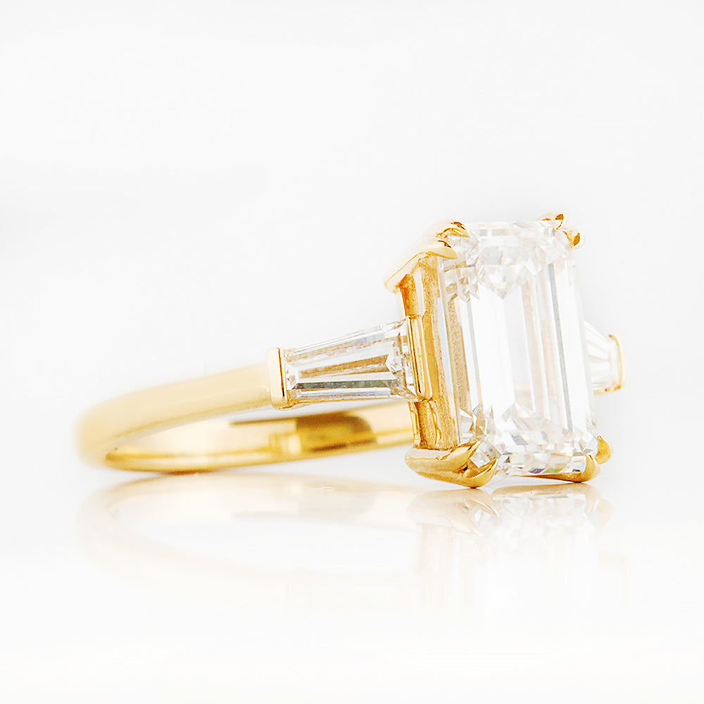 Carmen, an Emerald cut Trilogy Ring