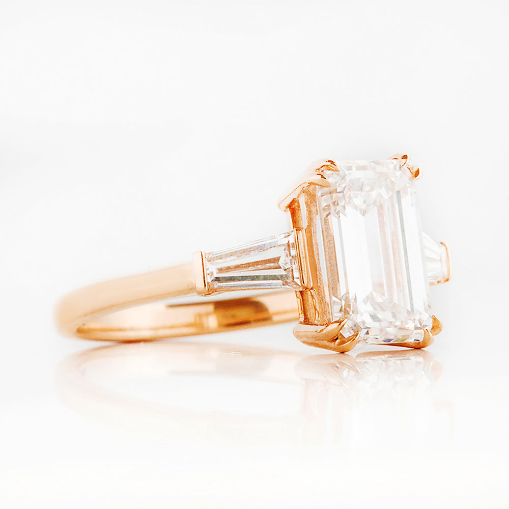 Carmen, an Emerald cut Trilogy Ring