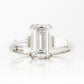 Carmen, an Emerald cut Trilogy Ring