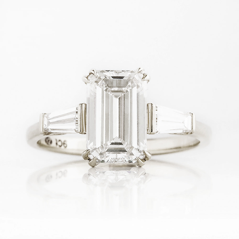 Carmen, an Emerald cut Trilogy Ring