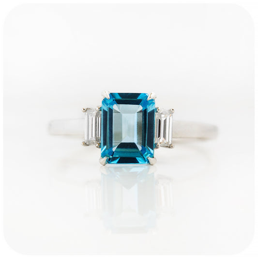 Emerald cut Swiss Blue Topaz and Baguette cut Moissanite Trilogy Engagement Ring - Victoria's Jewellery