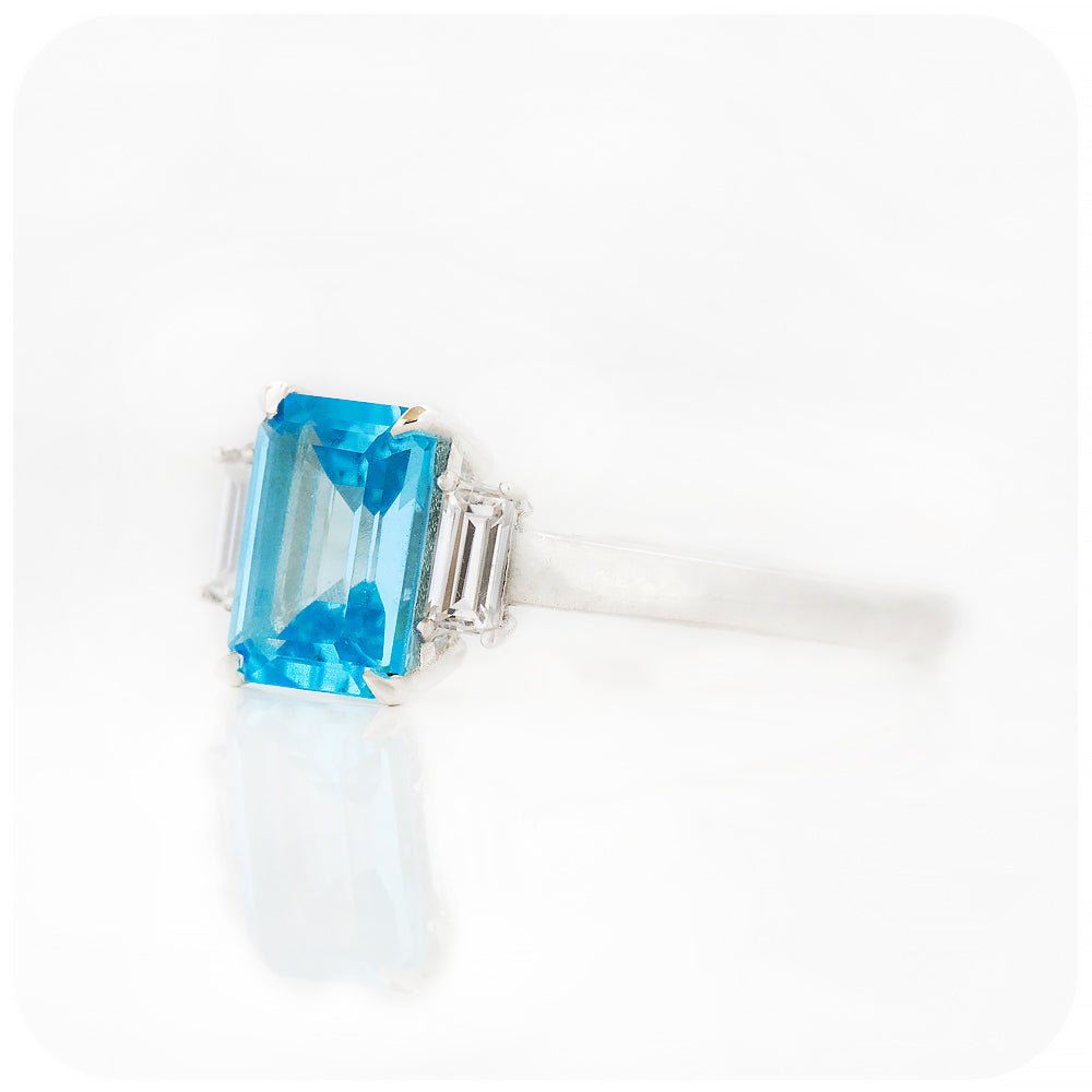 Emerald cut Swiss Blue Topaz and Baguette cut Moissanite Trilogy Engagement Ring - Victoria's Jewellery