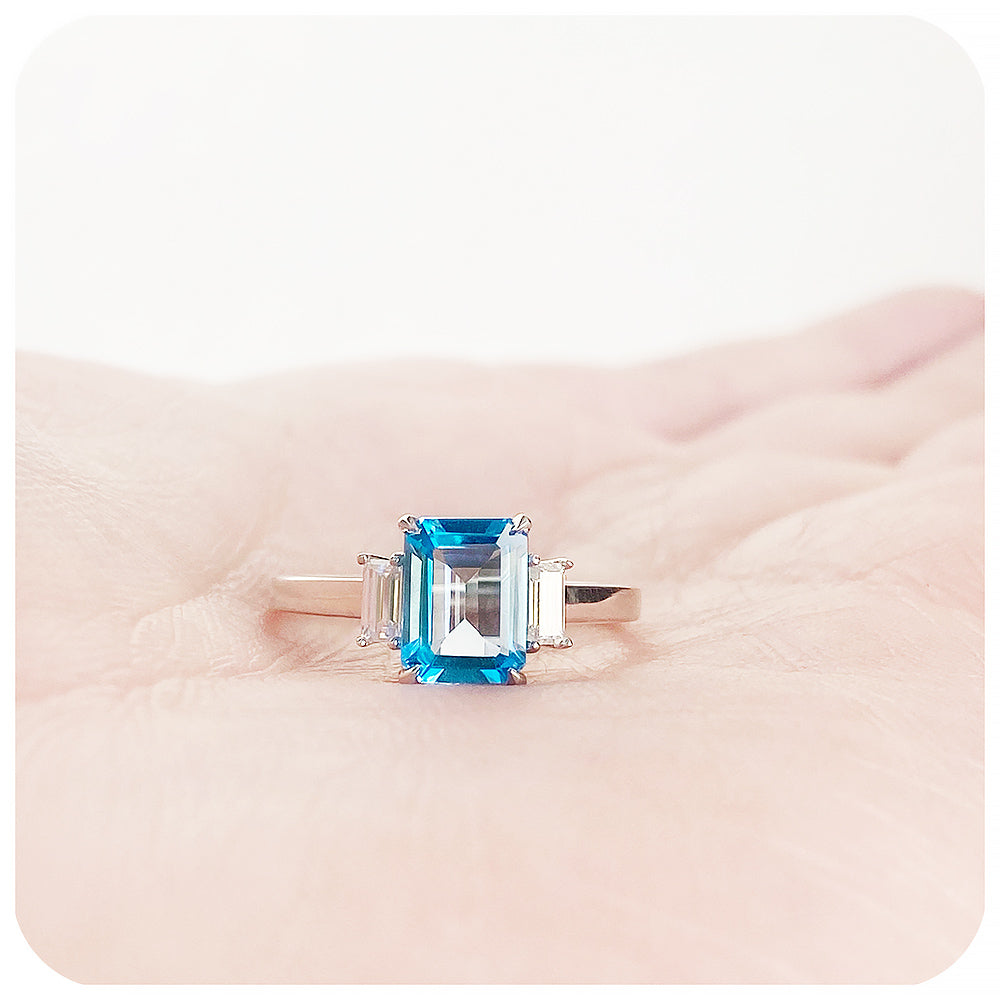 Emerald cut Swiss Blue Topaz and Baguette cut Moissanite Trilogy Engagement Ring - Victoria's Jewellery