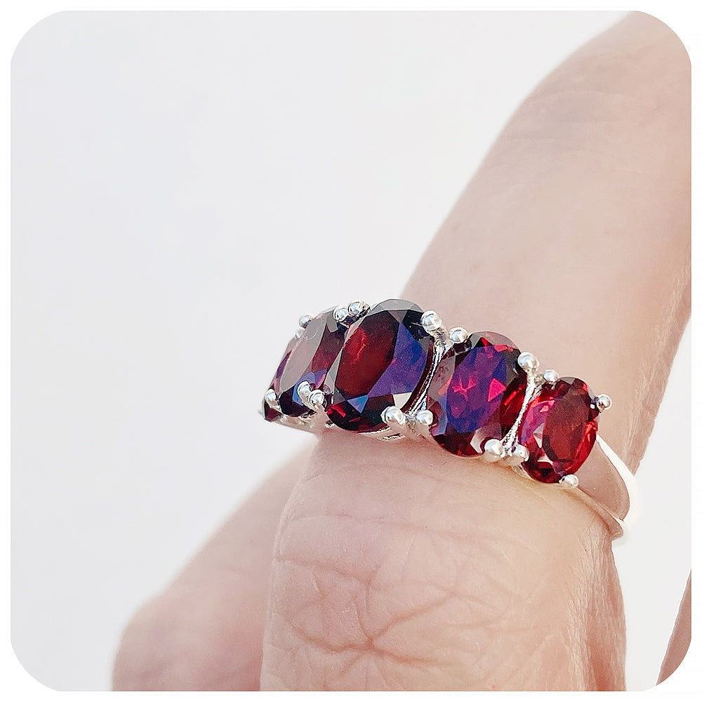 oval cut red garnet half eternity anniversary or birthstone ring