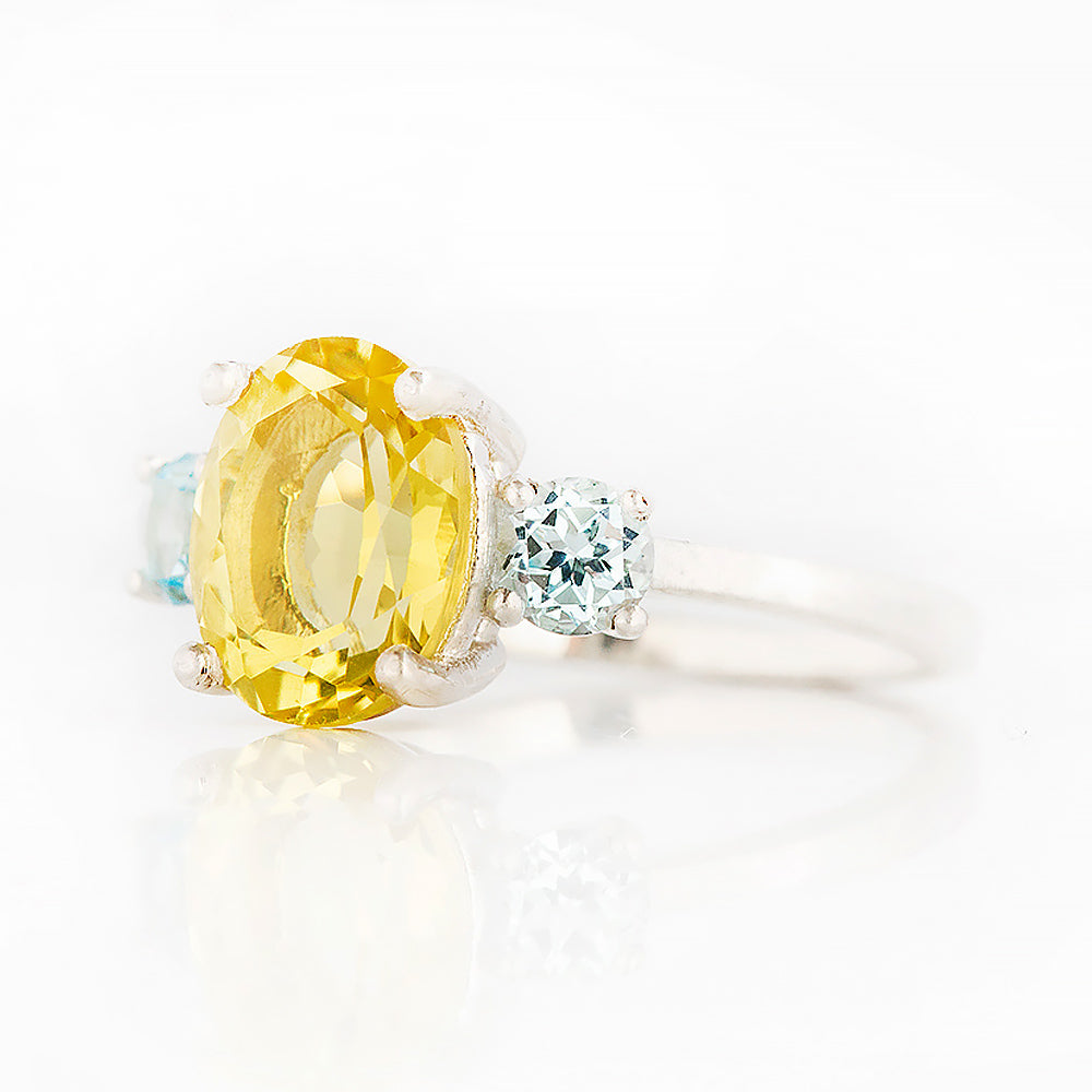Hallie, an Oval cut Lemon Quartz and Topaz Trilogy Ring
