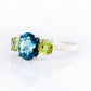 Lucy, a London Blue Topaz and Peridot Trilogy Ring - Victoria's Jewellery