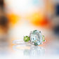 Hallie, an Oval cut Prasiolite and Peridot Trilogy Ring