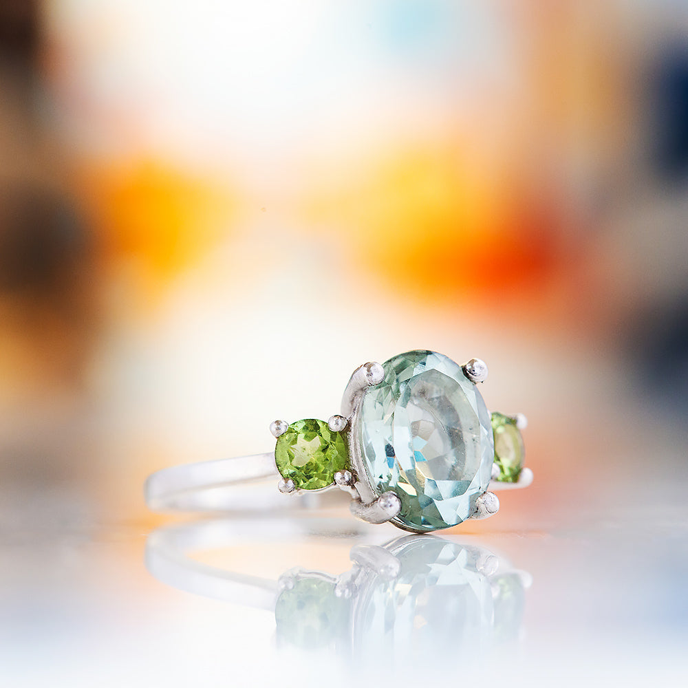 Hallie, an Oval cut Prasiolite and Peridot Trilogy Ring
