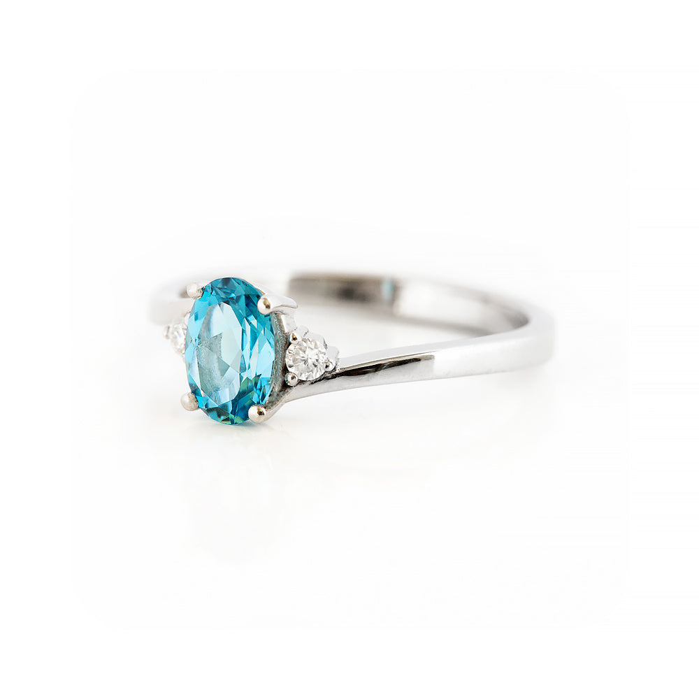 Oval cut Swiss Blue Topaz and Lab Diamond Trilogy Engagement Ring in White Gold - Victoria's Jewellery