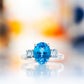 Hallie, an Oval cut Swiss Blue and Sky Blue Topaz Trilogy Ring