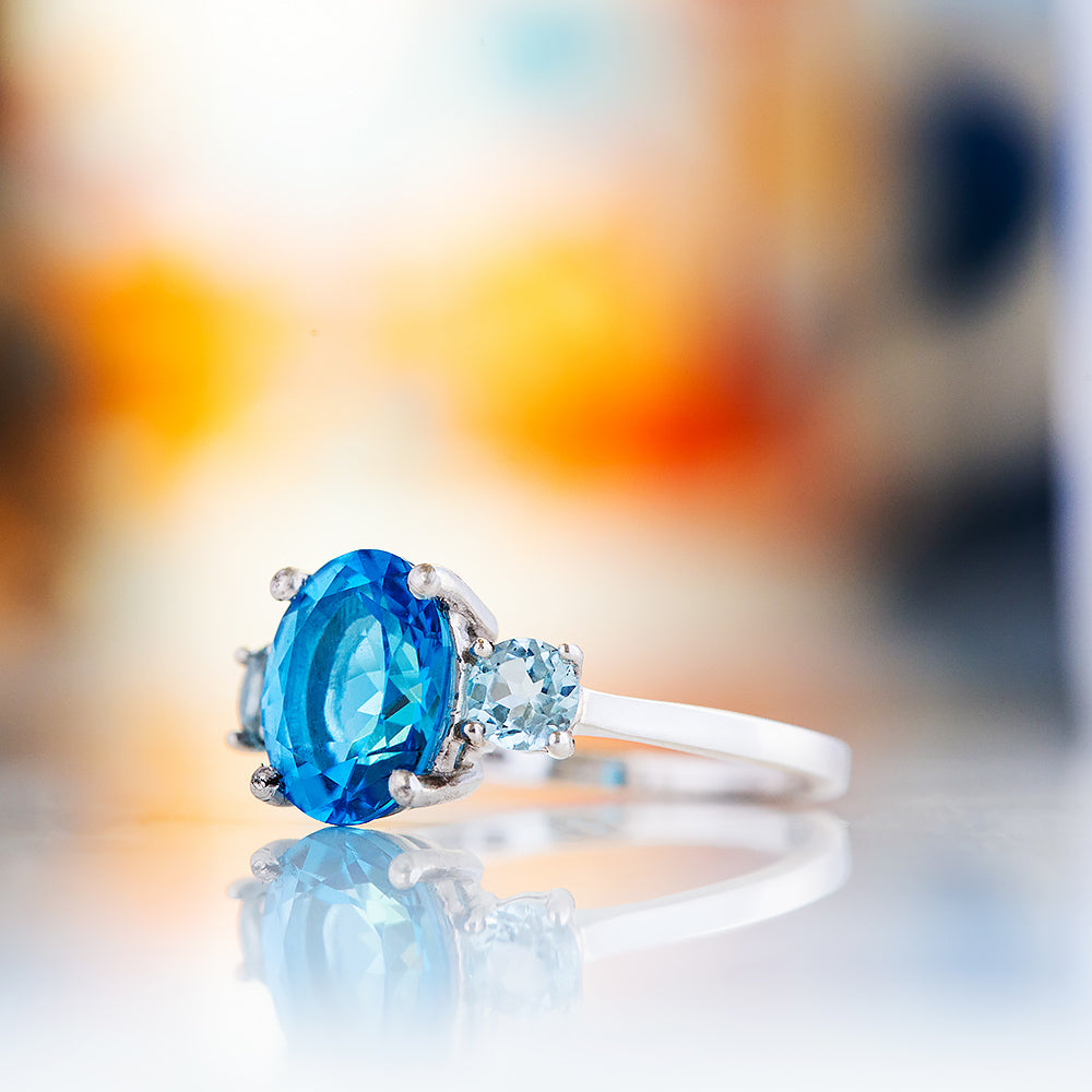 Hallie, an Oval cut Swiss Blue and Sky Blue Topaz Trilogy Ring