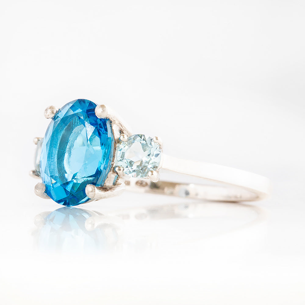 Hallie, an Oval cut Swiss Blue and Sky Blue Topaz Trilogy Ring