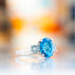 Hallie, an Oval cut Swiss Blue and Sky Blue Topaz Trilogy Ring