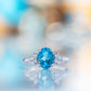 Este, an Oval cut Swiss Topaz and Lab Diamond Ring