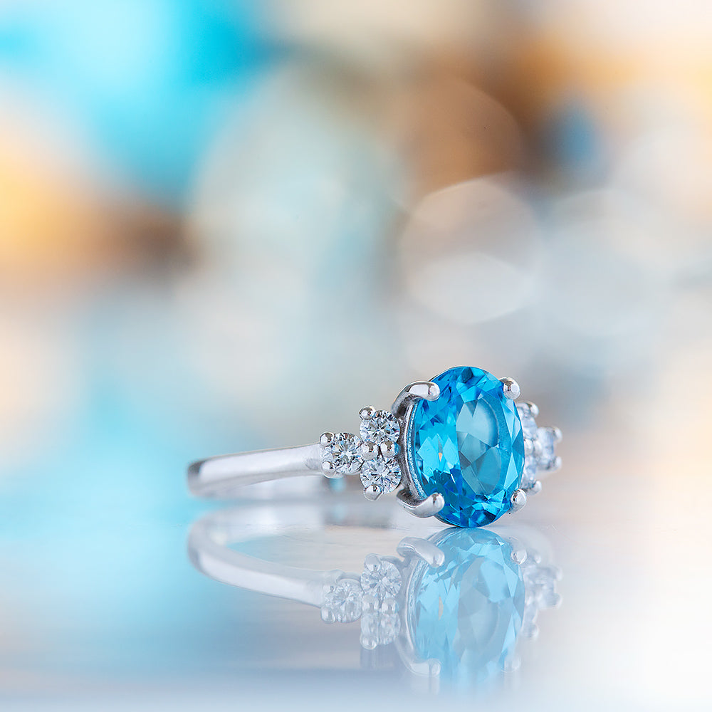 Este, an Oval cut Swiss Topaz and Lab Diamond Ring