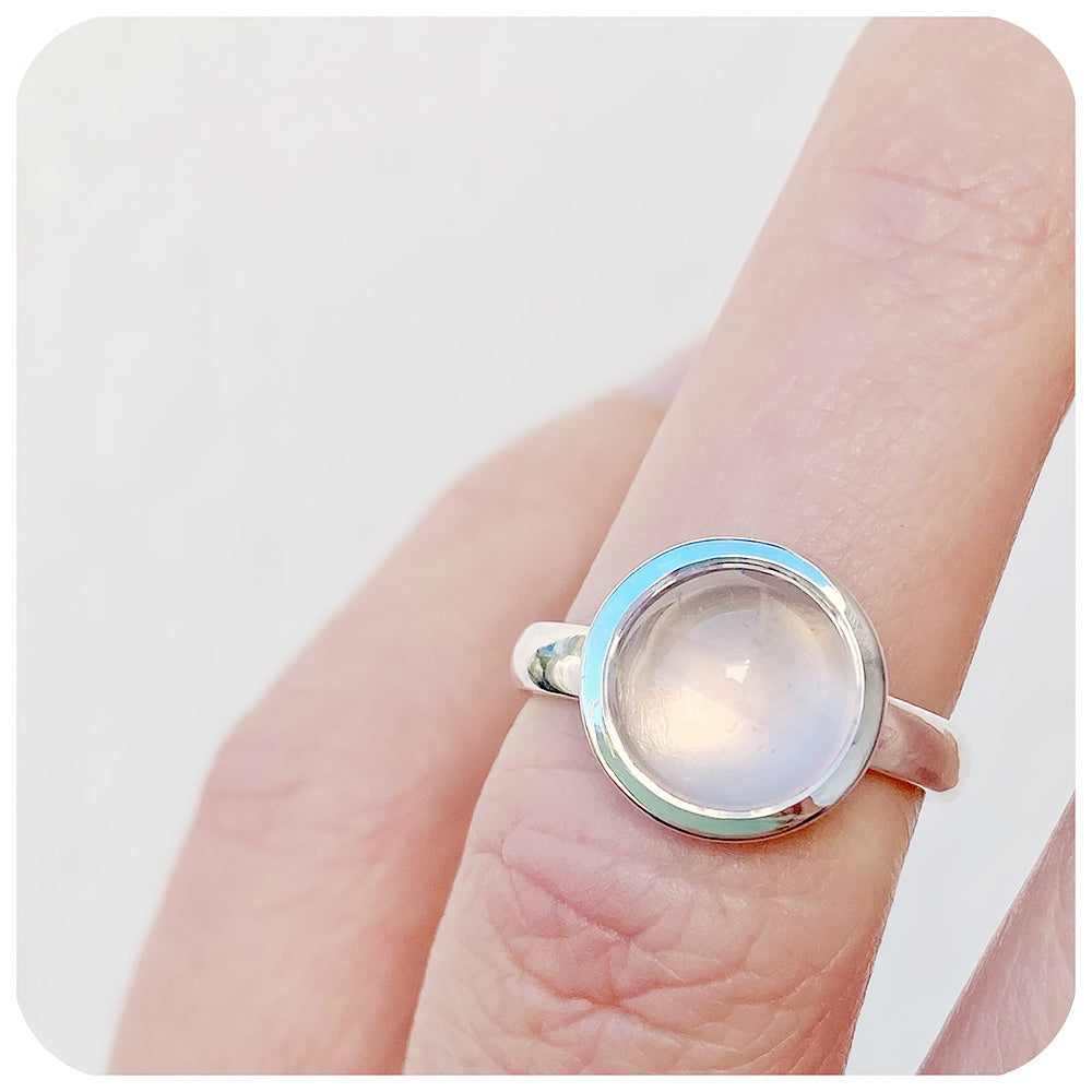 round cabochon rose quartz solitaire ring in a bezel setting