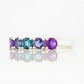Annie, a Blue and Purple Half Eternity Ring
