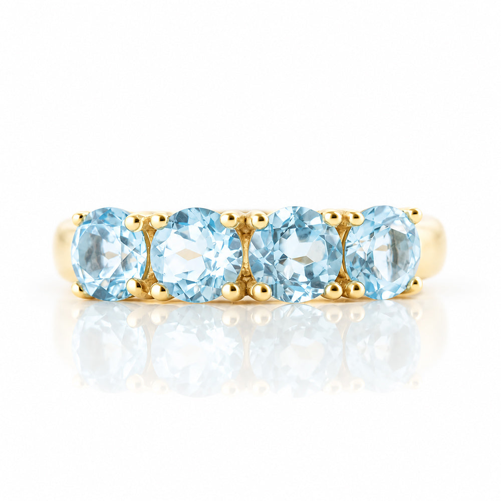 Celine, a Sky Blue Topaz Four Stone Half Eternity Ring