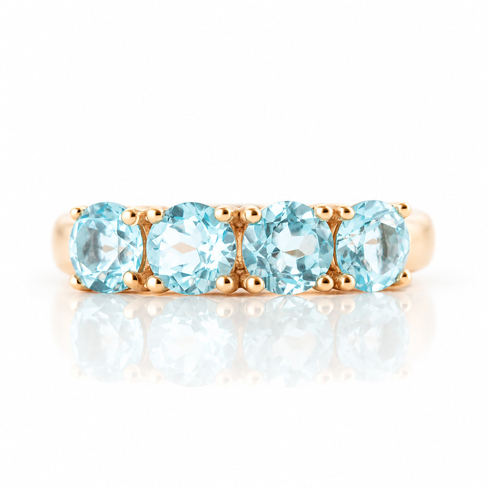 Celine, a Sky Blue Topaz Four Stone Half Eternity Ring