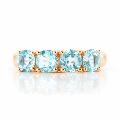 Celine, a Sky Blue Topaz Four Stone Half Eternity Ring